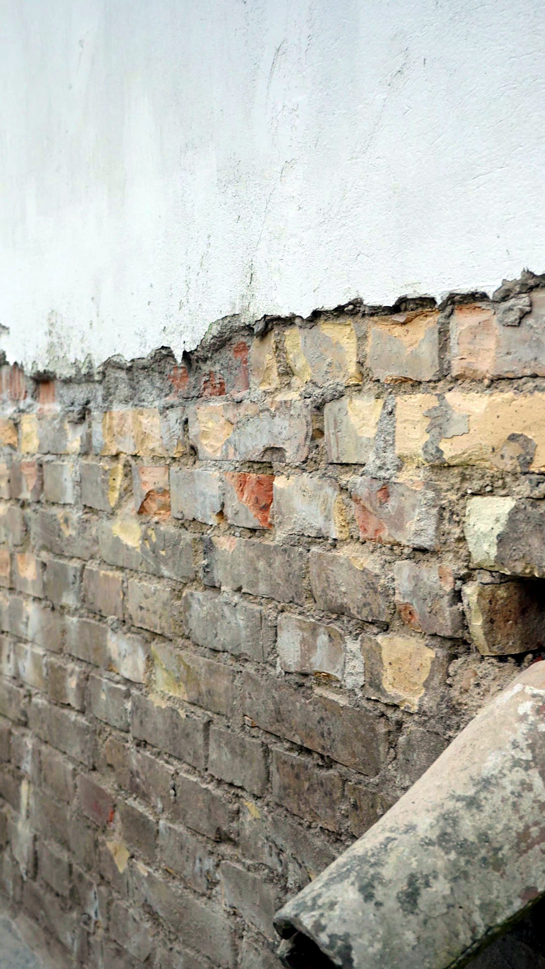 Il muro esterno con l intonaco demolito e i mattoni a vista, prima delle iniezioni di resina